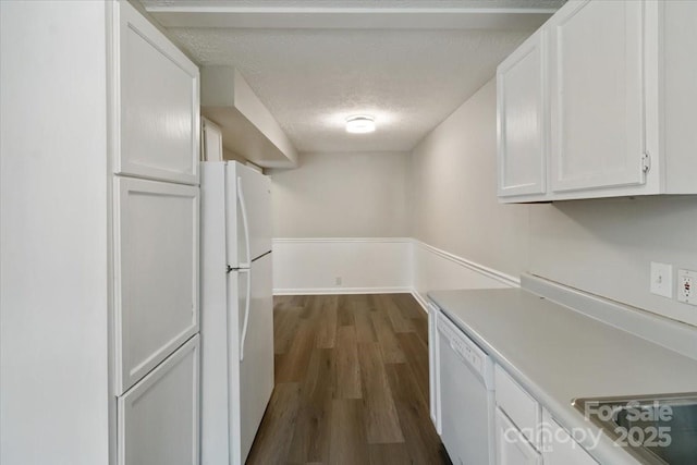 kitchen featuring white appliances, dark wood-style flooring, light countertops, a textured ceiling, and white cabinetry