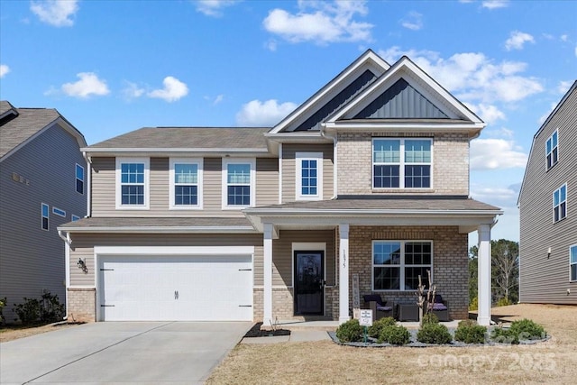 craftsman-style home with a garage, brick siding, covered porch, and driveway