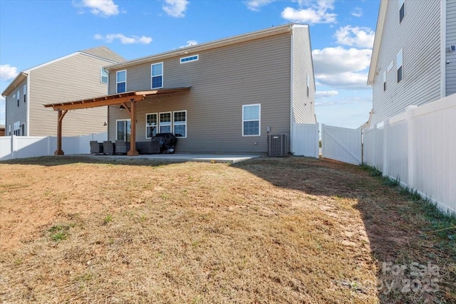 back of property with a fenced backyard, a lawn, a patio, and a gate