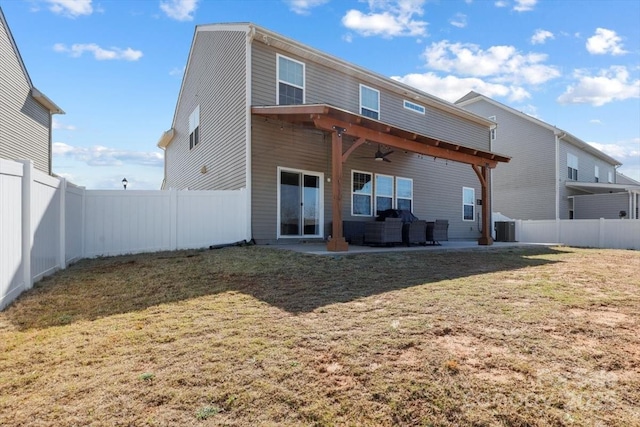 back of house with a patio, a lawn, a fenced backyard, and a ceiling fan