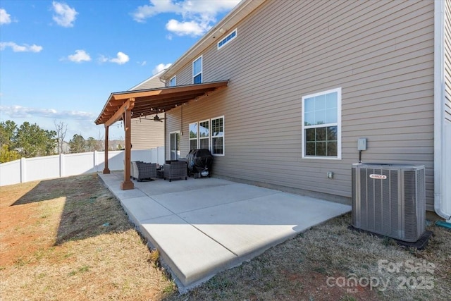 exterior space with a patio, central AC unit, a fenced backyard, outdoor lounge area, and a lawn