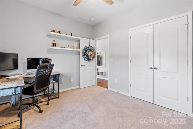 carpeted office with baseboards and ceiling fan