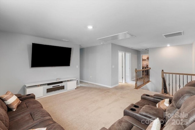 living room featuring visible vents, recessed lighting, baseboards, light colored carpet, and attic access