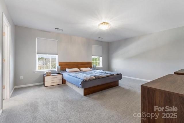 bedroom featuring baseboards, carpet floors, and visible vents