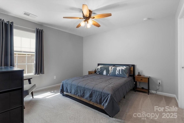 carpeted bedroom featuring baseboards, visible vents, and ceiling fan