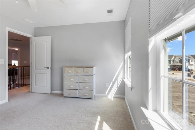 carpeted bedroom with visible vents and baseboards