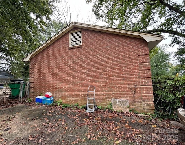 view of side of property featuring brick siding