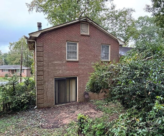 rear view of property featuring brick siding