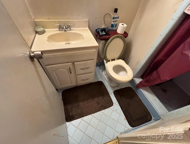 bathroom with vanity, a shower stall, toilet, and tile patterned floors