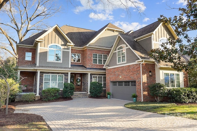 view of front of house featuring a garage, brick siding, driveway, and a shingled roof