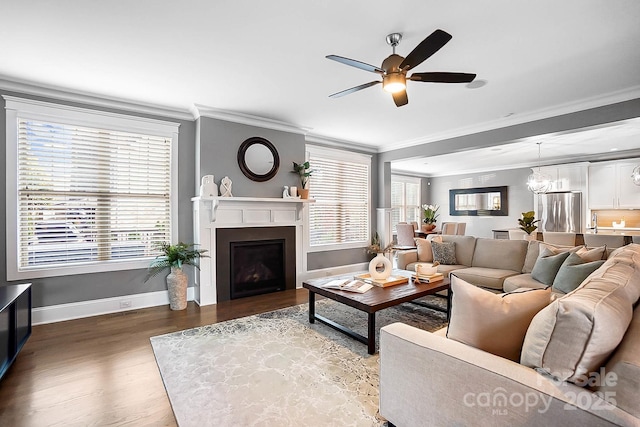 living room featuring a wealth of natural light, wood finished floors, ceiling fan, and a fireplace