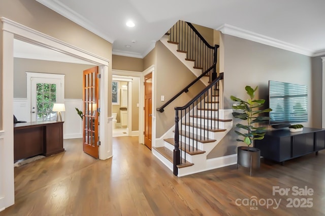 foyer entrance featuring stairway, wood finished floors, recessed lighting, ornamental molding, and french doors