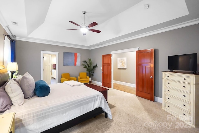 bedroom featuring baseboards, visible vents, crown molding, a raised ceiling, and light colored carpet