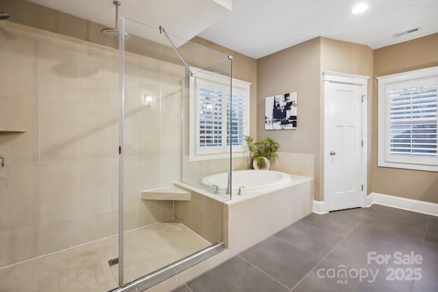 full bath with visible vents, a healthy amount of sunlight, and a shower stall