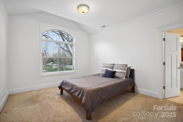 carpeted bedroom with visible vents, baseboards, and vaulted ceiling