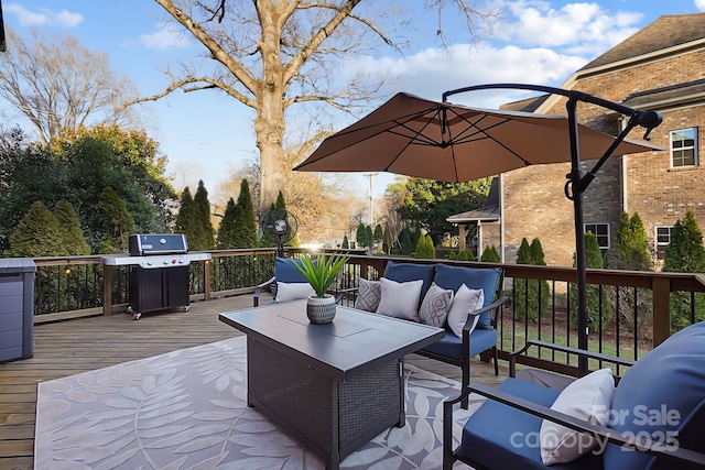 wooden terrace featuring a grill and outdoor lounge area