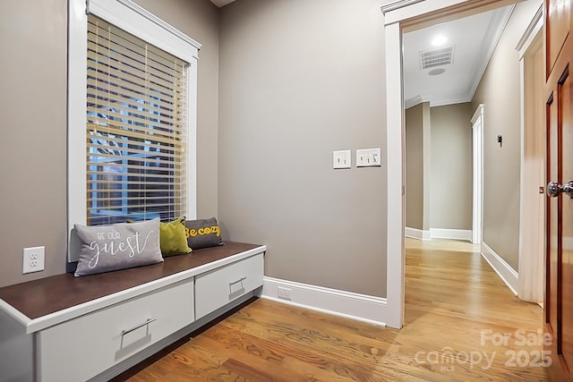 interior space featuring light wood finished floors, visible vents, and baseboards