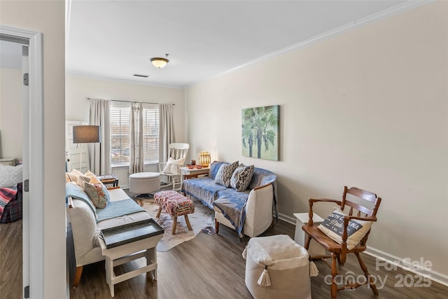 living area featuring visible vents, crown molding, baseboards, and wood finished floors