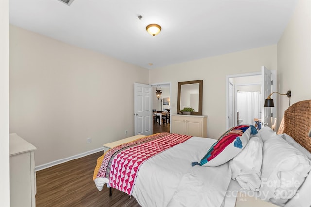 bedroom with dark wood-style floors and baseboards