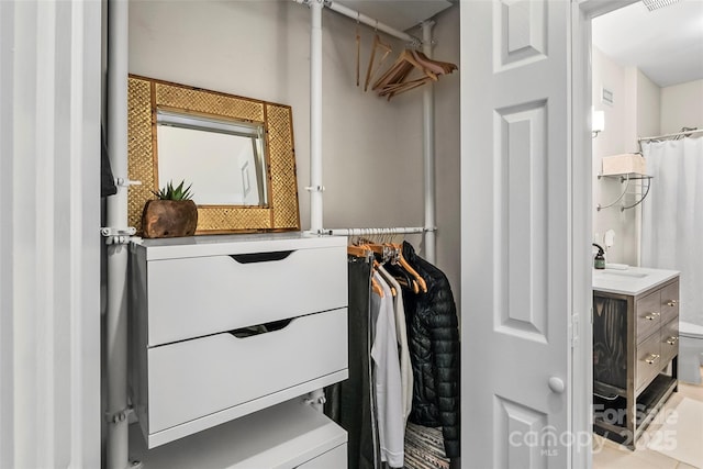 walk in closet featuring a sink and visible vents