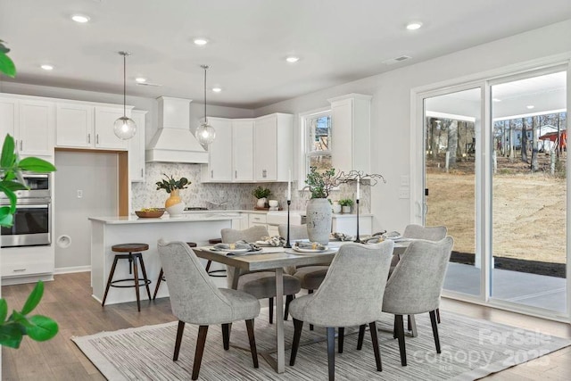 dining area featuring recessed lighting, wood finished floors, and visible vents