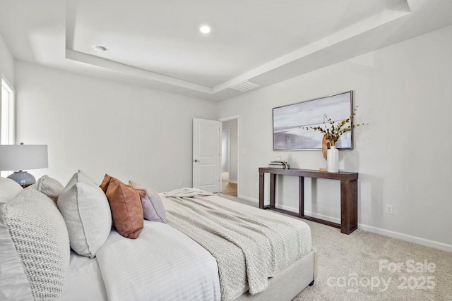 carpeted bedroom featuring a raised ceiling, recessed lighting, visible vents, and baseboards