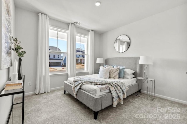 bedroom with carpet flooring, visible vents, and baseboards