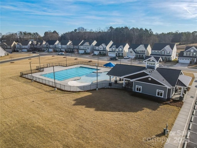 pool with fence and a residential view