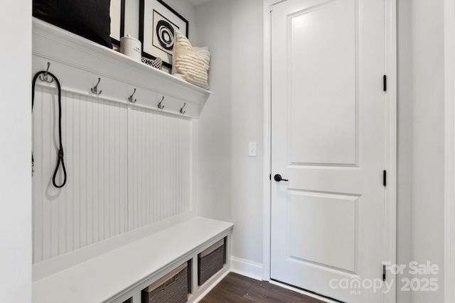 mudroom with baseboards and dark wood-style flooring