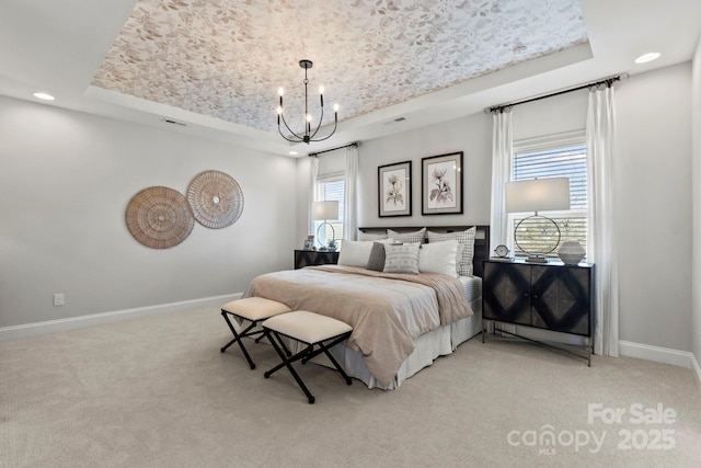 bedroom featuring light colored carpet and a raised ceiling