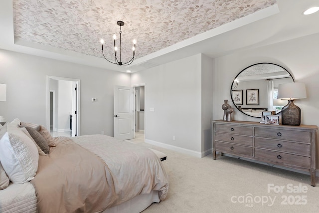 bedroom with an inviting chandelier, a tray ceiling, light colored carpet, and baseboards