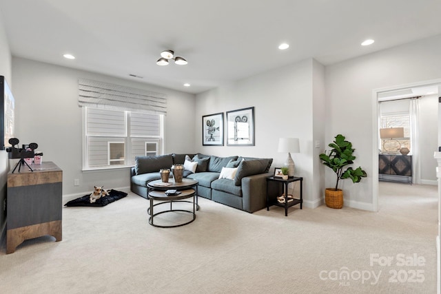 living area with carpet flooring, recessed lighting, visible vents, and baseboards