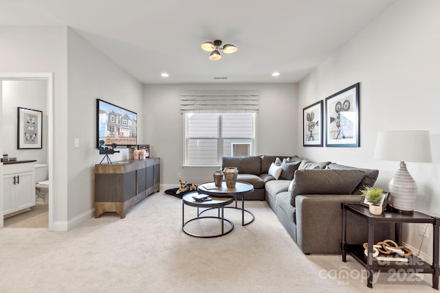 living room featuring recessed lighting, light colored carpet, and baseboards