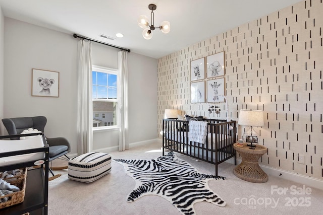 bedroom featuring visible vents, a notable chandelier, carpet, wallpapered walls, and baseboards