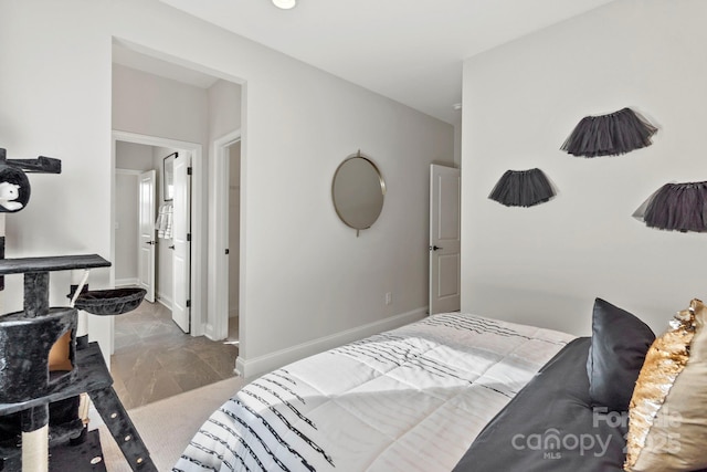 bedroom with baseboards and marble finish floor