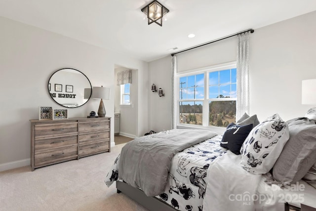 bedroom with baseboards, light carpet, and visible vents