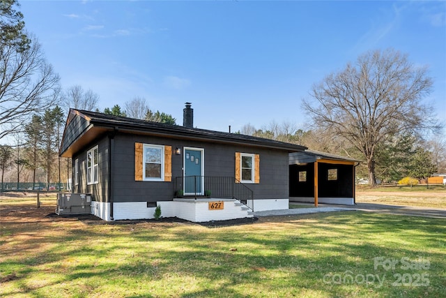 rear view of house featuring crawl space, central air condition unit, a yard, and a chimney