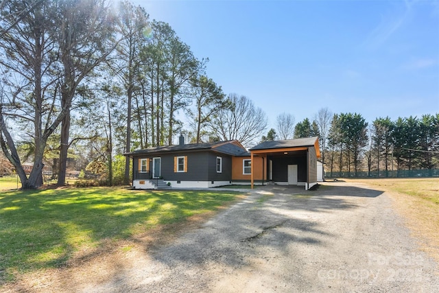 view of front of house with a front lawn, a carport, and driveway