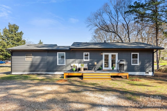 back of house featuring crawl space and a wooden deck