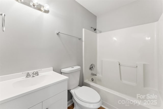 bathroom with tub / shower combination, toilet, and vanity