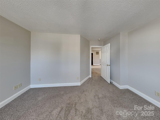 unfurnished room with baseboards and carpet flooring