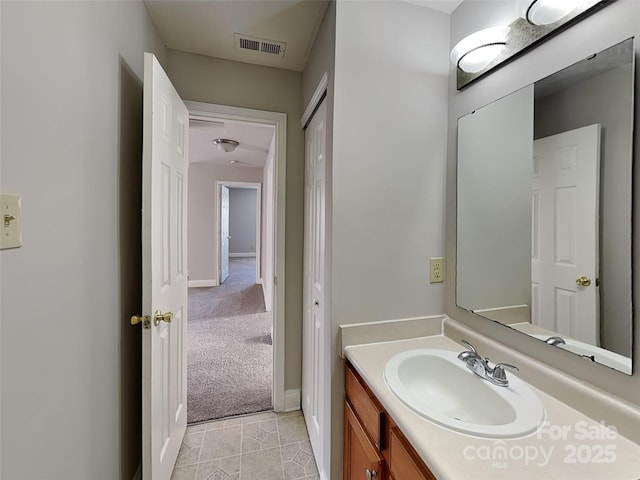 bathroom with vanity, tile patterned floors, baseboards, and visible vents