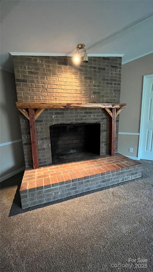 interior details with carpet flooring, a fireplace, crown molding, and baseboards