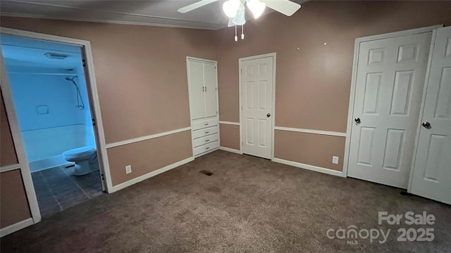 unfurnished bedroom featuring baseboards, carpet floors, and connected bathroom