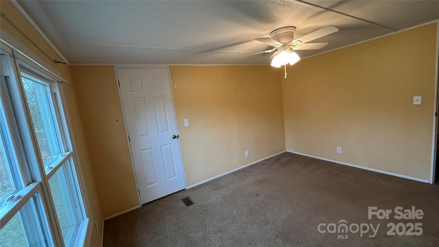 unfurnished bedroom with visible vents, carpet floors, baseboards, and ceiling fan