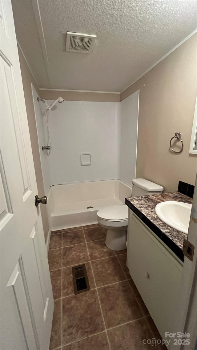 bathroom with visible vents, walk in shower, and vanity