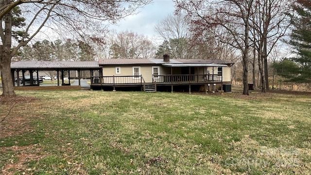 rear view of house with a yard, metal roof, and a deck