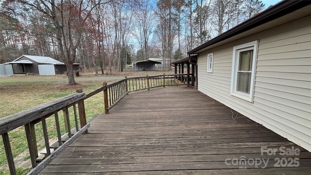 deck featuring an outbuilding and a lawn