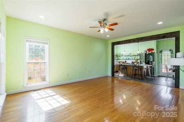 interior space featuring visible vents, baseboards, recessed lighting, ceiling fan, and hardwood / wood-style flooring