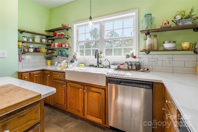 kitchen featuring dishwasher, open shelves, decorative backsplash, and a sink